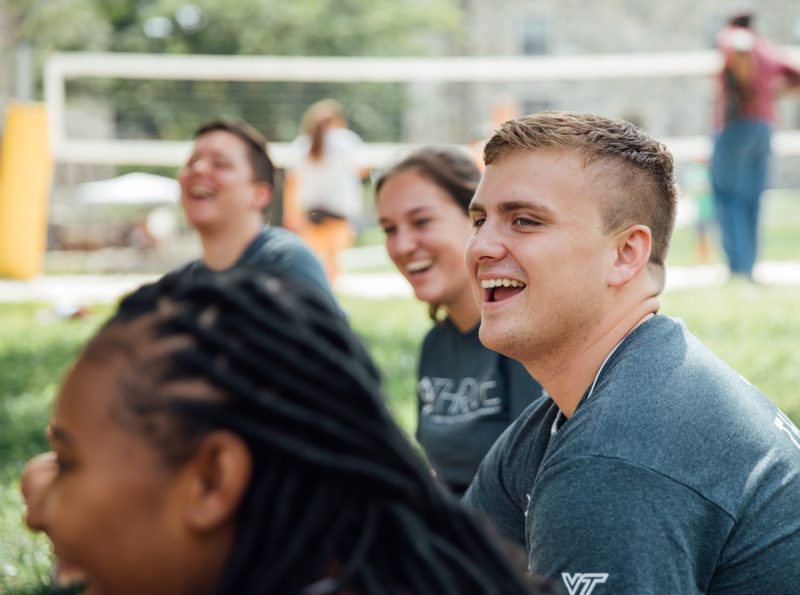 students walk under the archway at virginia tech